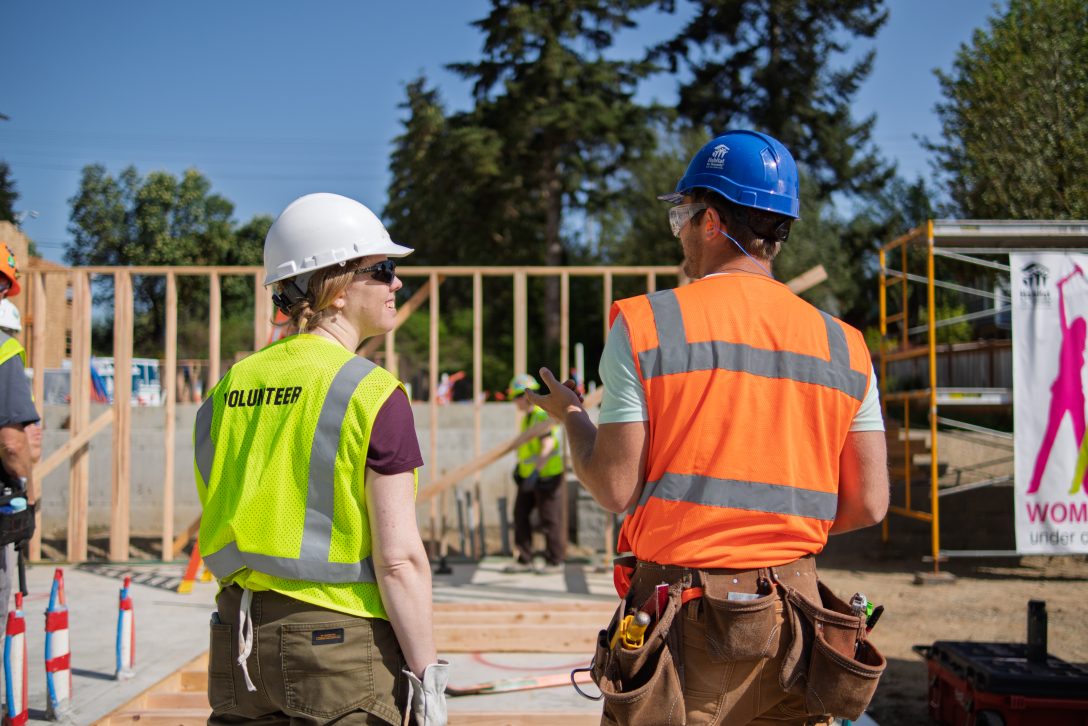 volunteer in yellow safety vest on build site