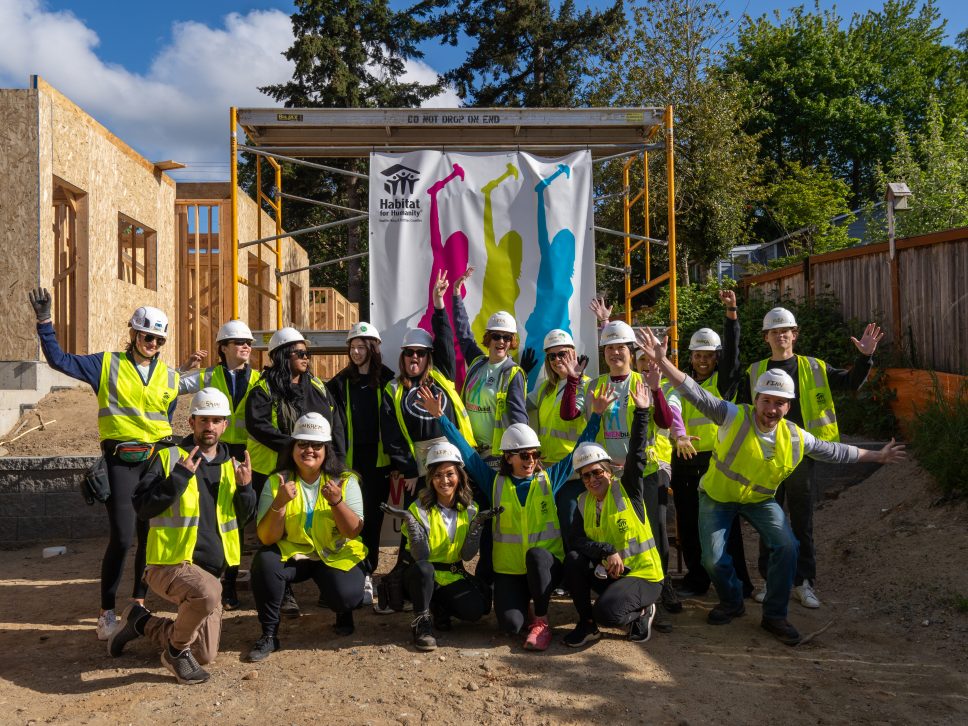 group of volunteers wearing helmets and yellow safety vests